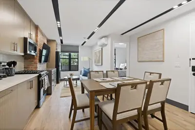a kitchen and dining room with a table and chairs at Luxury and Trendy 3BR 2BA APT only 20 minutes to New York in Jersey City