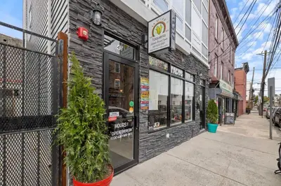 a store front of a brick building on a street at Luxury and Trendy 3BR 2BA APT only 20 minutes to New York in Jersey City