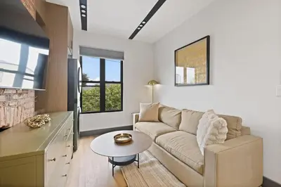 a living room with a couch and a table at New Luxury and Chic 3BR 2BA Apartment 20 Minutes to NYC in Jersey City