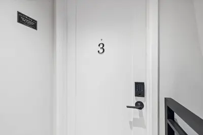 a door with the number three on it at New Luxury and Chic 3BR 2BA Apartment 20 Minutes to NYC in Jersey City
