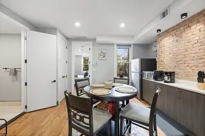 a kitchen and dining room with a table and chairs at Luxury and Chic 2BR 2BA Apt only 15 Mins to NYC & Hoboken in Jersey City