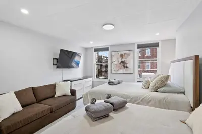 a living room with a couch and a bed at New and Beautiful 2BR Apt in Prime Spot 20 Min to NYC in Jersey City
