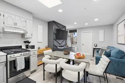 a kitchen and living room with a table and chairs at New and Beautiful 2BR Apt in Prime Spot 20 Min to NYC in Jersey City