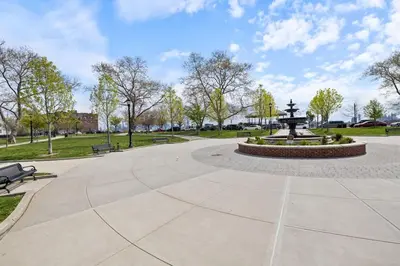 a park with a fountain and benches in a park at New and Beautiful 2BR Apt in Prime Spot 20 Min to NYC in Jersey City