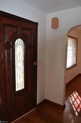 a wooden door with a stained glass window in a room at Single Family Homes Dunelle in Dunellen