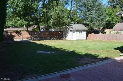 a backyard with a fence and a yard with a yard at Single Family Homes Dunelle in Dunellen