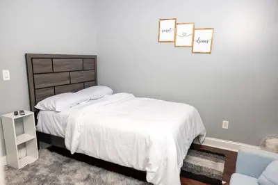 a bedroom with a bed and two pictures on the wall at Airende in Newark
