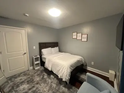 a bedroom with a bed and a chair at Airende in Newark