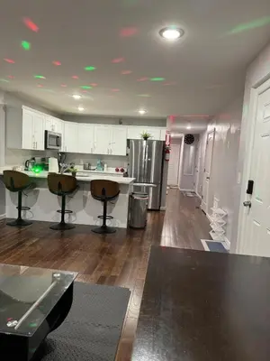 a kitchen with white cabinets and a counter top at Cozy 3-Bedroom Apartment in Newark near NYC in Newark