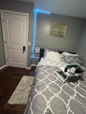 a bedroom with a bed and a blue light at Cozy 3-Bedroom Apartment in Newark near NYC in Newark