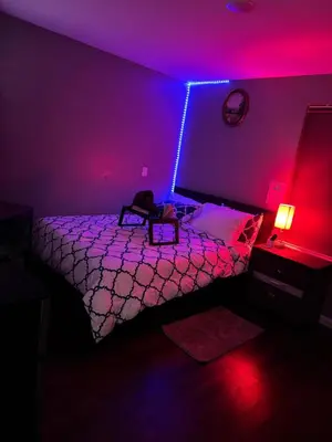 a bedroom with a bed with purple lights on it at Cozy 3-Bedroom Apartment in Newark near NYC in Newark