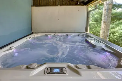 a jacuzzi tub with a thermometer in it at Lakefront Cottage with Dock, Hot Tub and Fire Pit in Greentown