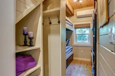 a small room with bunk beds in a tiny house at Lakefront Cottage with Dock, Hot Tub and Fire Pit in Greentown
