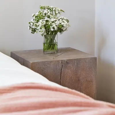 a vase of flowers sitting on a wooden table at 11 Howard, New York, a Member of Design Hotels in New York
