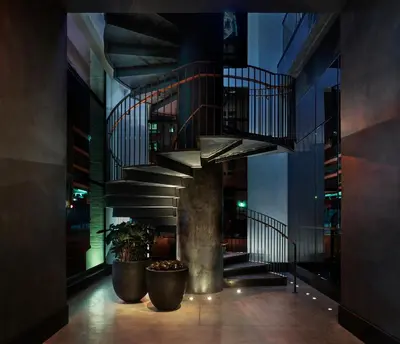 a hallway with a spiral staircase in a building at 11 Howard, New York, a Member of Design Hotels in New York