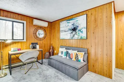a living room with a couch and a desk at Scenic Views! Clifton Twp Chalet with Fire Pit, Deck in Gouldsboro