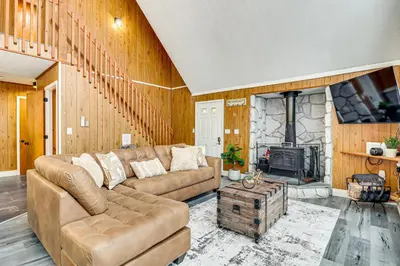 a living room with a couch and a fireplace at Scenic Views! Clifton Twp Chalet with Fire Pit, Deck in Gouldsboro