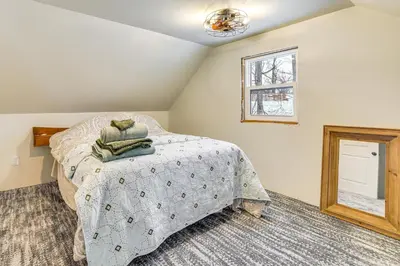 a bedroom with a bed and a window at Pool, Beach and Lake Access Poconos Cabin Escape! in Tobyhanna