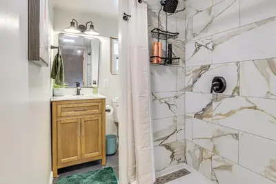 a bathroom with a shower and a sink at Pool, Beach and Lake Access Poconos Cabin Escape! in Tobyhanna