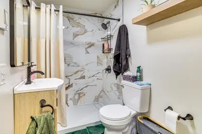a bathroom with a toilet and a sink and a shower at Pool, Beach and Lake Access Poconos Cabin Escape! in Tobyhanna