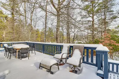 a deck with a table and chairs covered in snow at Vibrant Hideaway on Shores of West Emerald Lake! in Long Pond