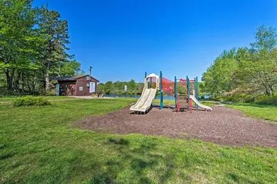 a playground with a slide in a park at Vibrant Hideaway on Shores of West Emerald Lake! in Long Pond