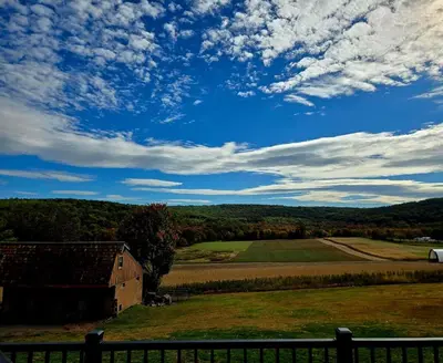 a view of a farm with a barn in a field at Just Like Home, Overlooks Maple Grove Raceway in Mohnton