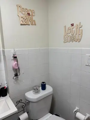 a white bathroom with a toilet and a sink at Private Room 15 Mins to Times Square NYC in West New York