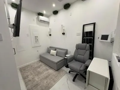 a salon room with two chairs and a table at Modern Tiny Home Fast NYC Access Private in Jersey City