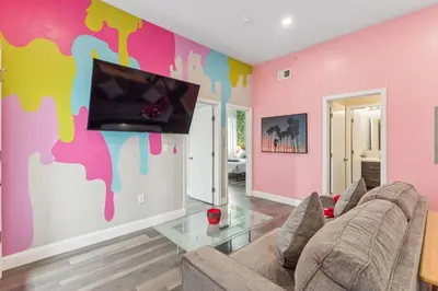 a living room with a couch and a tv on a wall at Stay at Luna on 16th & Ridge Ave in Philadelphia