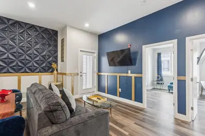 a living room with a couch and a tv on a wall at Stay at Luna on 16th & Ridge Ave in Philadelphia