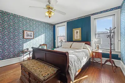 a bedroom with a bed in a room with blue walls at The Manheim Manor in Manheim