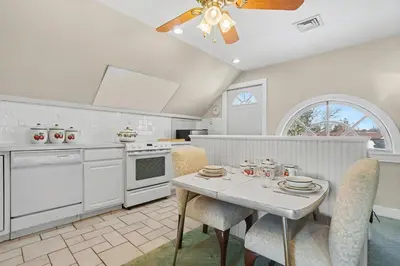 a kitchen with a table with chairs and a ceiling fan at The Manheim Manor in Manheim