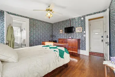 a bedroom with a bed and a tv on the wall at The Manheim Manor in Manheim