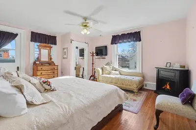 a bedroom with a large bed and a fireplace at The Manheim Manor in Manheim