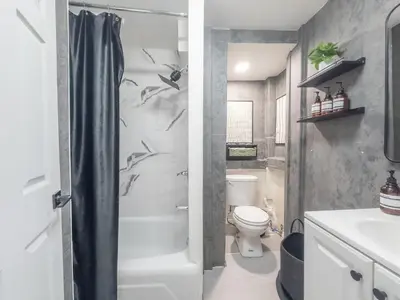 a bathroom with a shower and a toilet and a sink at New Calm Cocoon by Train We Pay Half Parking, Sleeps 6 in Hoboken
