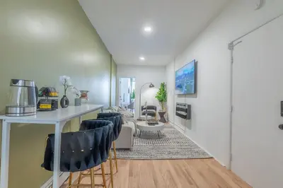 a living room with a table and chairs at New Calm Cocoon by Train We Pay Half Parking, Sleeps 6 in Hoboken
