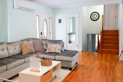 a living room with a couch and a table at Family River Valley Retreat with Fireplace in Sparrow Bush