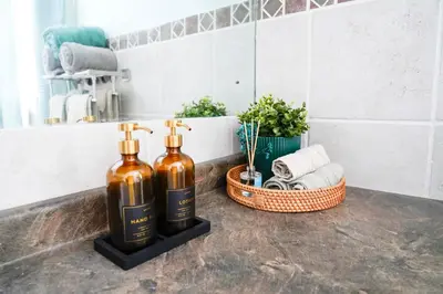 two bottles of wine sitting on a counter in a bathroom at Family River Valley Retreat with Fireplace in Sparrow Bush
