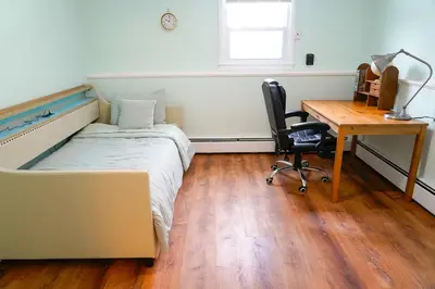 a bedroom with a bed and a desk and a desk at Family River Valley Retreat with Fireplace in Sparrow Bush
