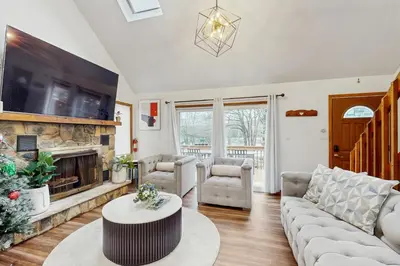 a living room with a couch and a fireplace at Lakeside Escape in Blakeslee