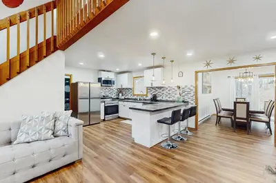 a kitchen and living room with a couch and a table at Lakeside Escape in Blakeslee