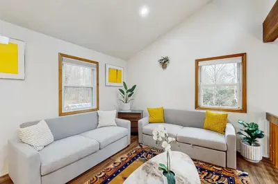 a living room with two couches and a table at Lakeside Escape in Blakeslee
