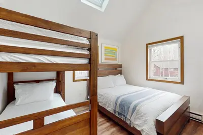 a bedroom with two bunk beds and a window at Lakeside Escape in Blakeslee