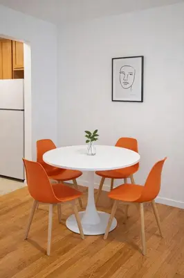 a white table and chairs with a plant on it at Elegant NYC Apartment with Designer Touches in New York