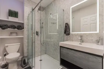 a bathroom with a shower and a toilet and a sink at University City Executive Modern 3BR 2BA Within 5 min to Drexel, University of Pennsylvania, & Children's Hospital of Pennsylvania in Philadelphia