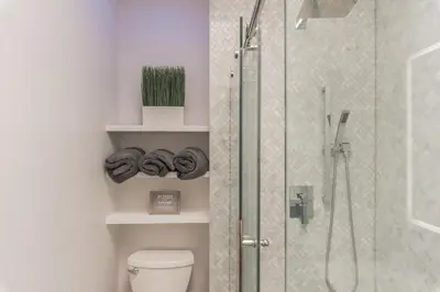 a bathroom with a shower and a toilet with a glass door at University City Executive Modern 3BR 2BA Within 5 min to Drexel, University of Pennsylvania, & Children's Hospital of Pennsylvania in Philadelphia