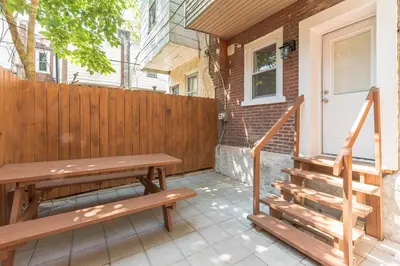 a patio with a wooden bench and a fence at University City Executive Modern 3BR 2BA Within 5 min to Drexel, University of Pennsylvania, & Children's Hospital of Pennsylvania in Philadelphia