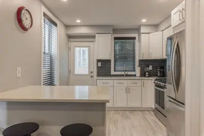 a kitchen with white cabinets and a counter top at University City Executive Modern 3BR 2BA Within 5 min to Drexel, University of Pennsylvania, & Children's Hospital of Pennsylvania in Philadelphia