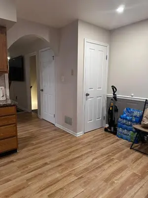 an empty living room with wooden floors and white walls at Home Away From Home in Ridley Park